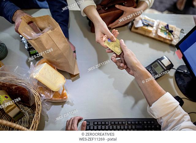 Customer paying with credit card in a farm shop