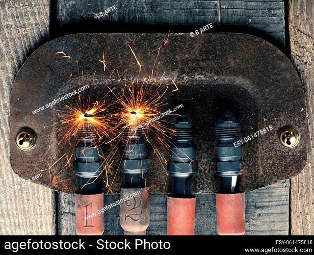 Second Advent background with four spark plugs on rusty sign, car workshop advent, concept image