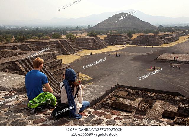People at the top of the Temple of the Moon with the Temple of the Sun at the background in Teotihuacan Ruins, Teotihuacan Archaeological Site, Mexico City