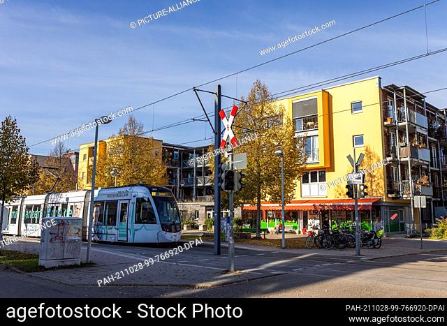 27 October 2021, Baden-Wuerttemberg, Freiburg: A tram travels through Freiburg's Vauban district. The Vauban is considered an ecological showcase in urban...