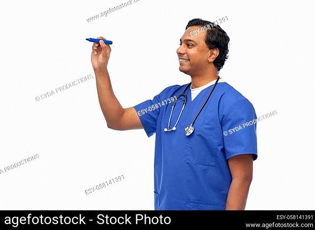 indian male doctor writing something with marker