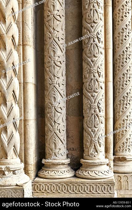 The elaborately engraved Romanesque style stone pillars of the main portal entrance to the Old Cathedral Se Velha in Coimbra, Beira Litoral, Portugal