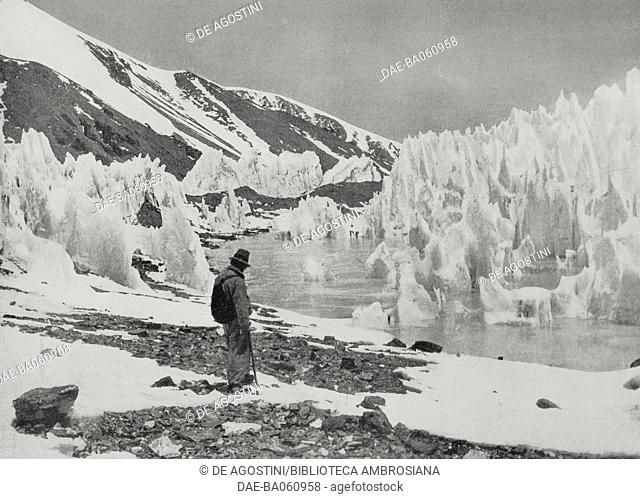 A mountaineer contemplates the fabulous ice scenery of Everest, Himalayas, on the border between China and Nepal, photo from L'illustrazione Italiana, year LX