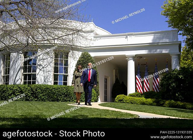 United States President Donald J. Trump (R) and first lady Melania Trump (L) walk outside the West Wing to participate in a tree planting ceremony to...