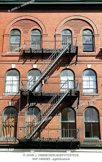 An old building complete with fire escapes in downtown Bangor, Maine, USA  Bangor is the 3rd largest city in the state and the retail
