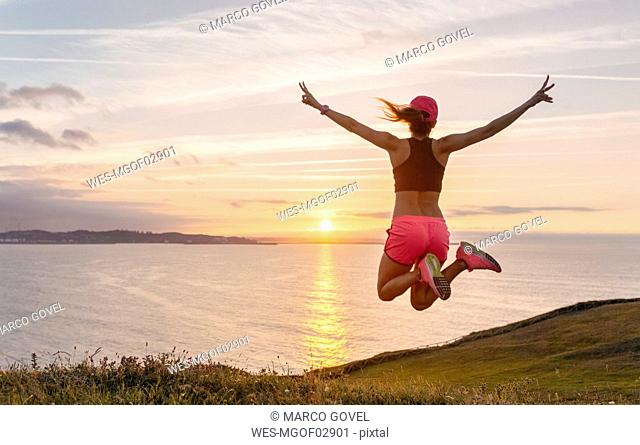 Female athlete jumping for joy