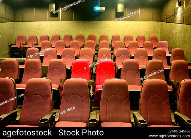 Empty seats in cinema movie theater with two red chairs