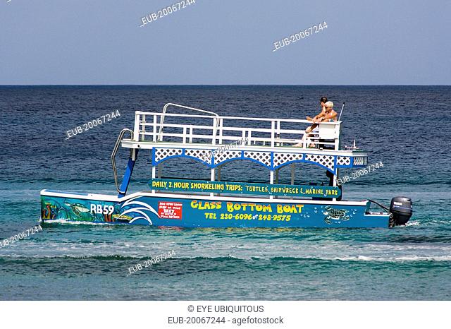 Tourists on glass bottom boat off the beach at Holetown
