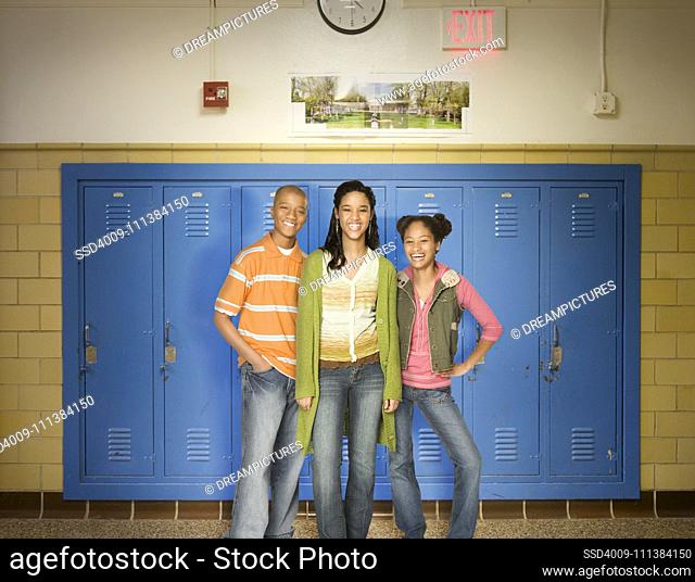 Teenagers standing near lockers in school
