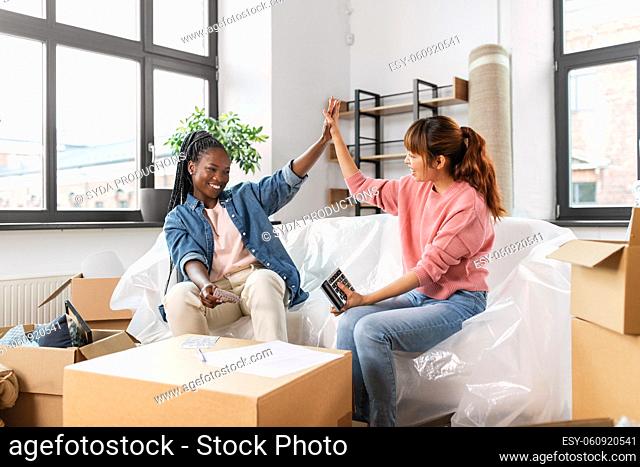 happy women moving to new home and counting money