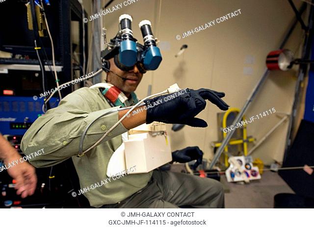 Astronaut Robert Satcher, STS-129 mission specialist, uses virtual reality hardware in the Space Vehicle Mock-up Facility at NASA's Johnson Space Center to...