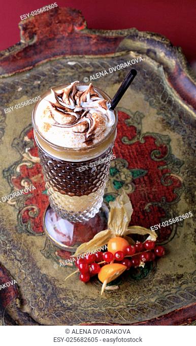 Liqueur coffee with whipped cream in a tall glass