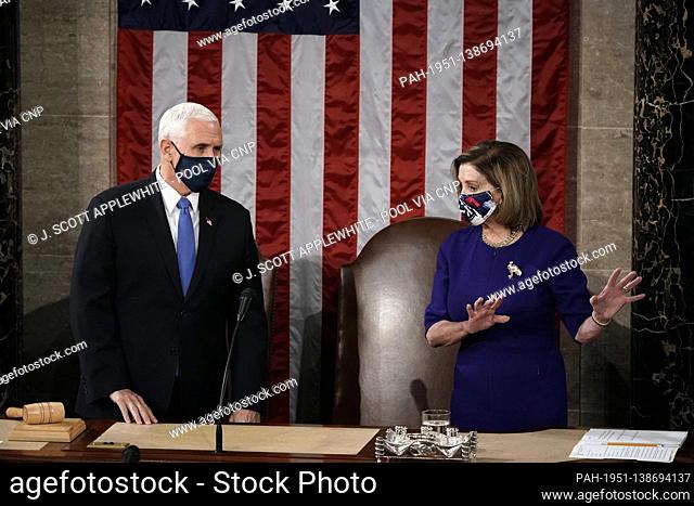 Speaker of the House Nancy Pelosi, D-Calif., and Vice President Mike Pence talk before a joint session of the House and Senate convenes to count the Electoral...