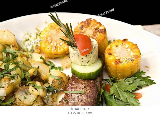 A rump steak with assorted vegetables on a plate