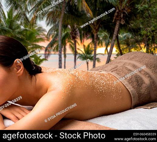 close up of woman with sea salt on skin at spa