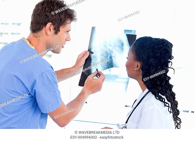Happy doctors looking at a of X-ray