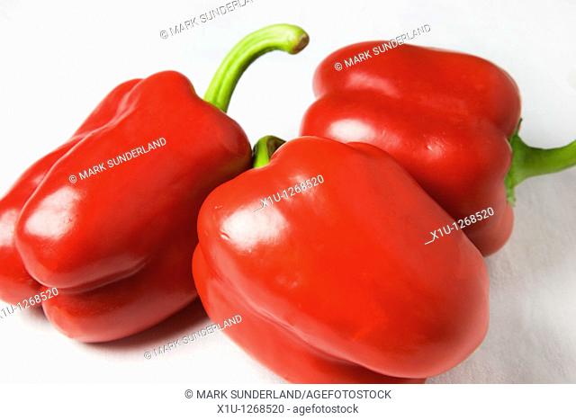 Three Red Peppers on a White Background