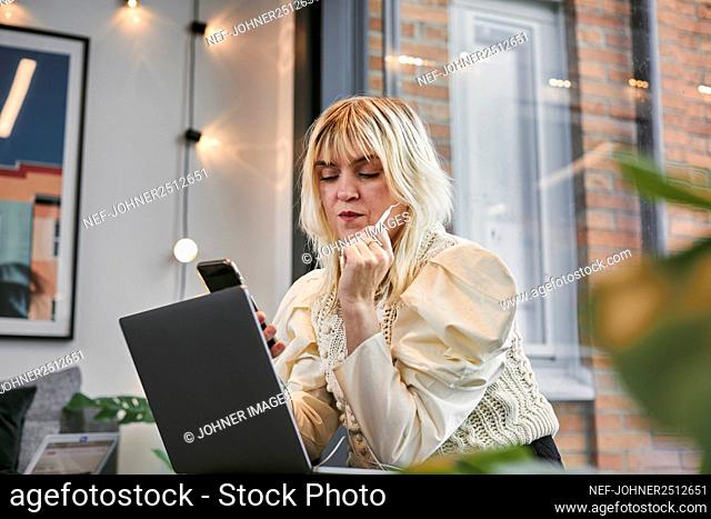 Businesswoman in office using phone