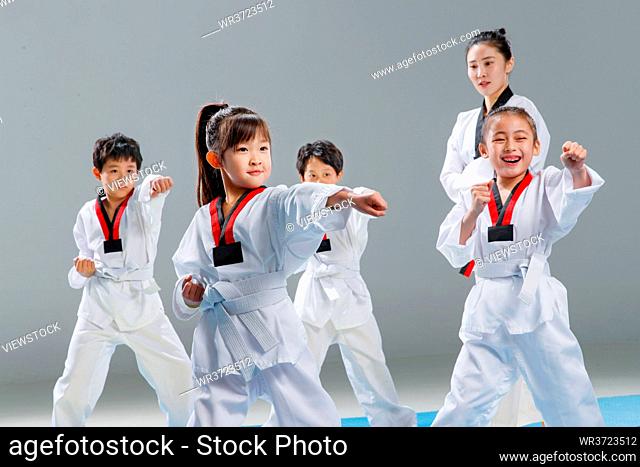 Young coaches teach pupils learn tae kwon do
