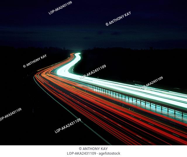 England, Essex, near Harlow. Light trails from traffic on the M11 motorway at night