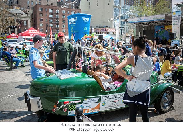 Visitors to Union Square in New York explore a high school student built electric car on display at the Earth Day New York fair
