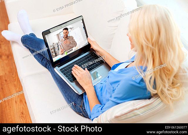 woman with laptop watching tutorial video at home