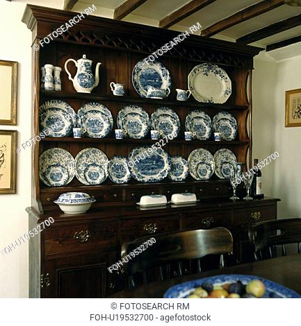 Blue and white china on oak dresser in cottage dining room