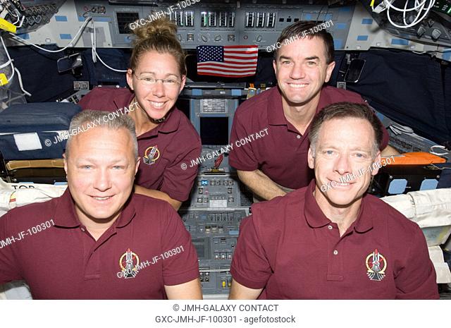 The four crew members of the Atlantis STS-135 mission pose for a picture on the spacecraft's flight deck. On the front row are NASA astronauts Doug Hurley...