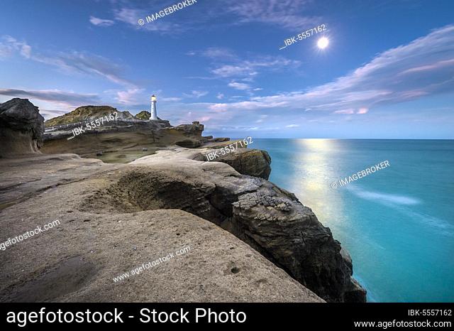 Lighthouse at full moon on the cliffs of lava rock at Castlepoint, Masterton, Wellington, New Zealand, Oceania