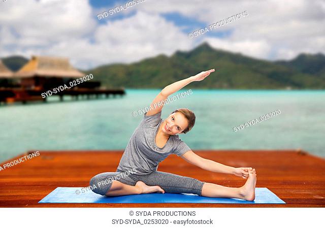 happy woman making yoga and stretching outdoors