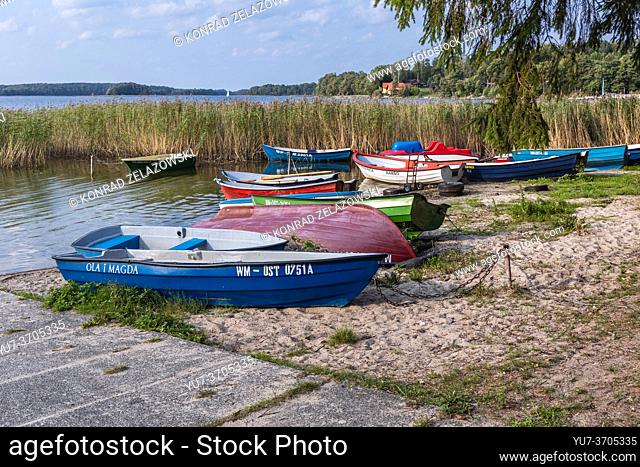 Boats on shore of Narie Lake located in Ilawa Lakeland region, view from Kretowiny village, Ostroda County, Warmia and Mazury province of Poland