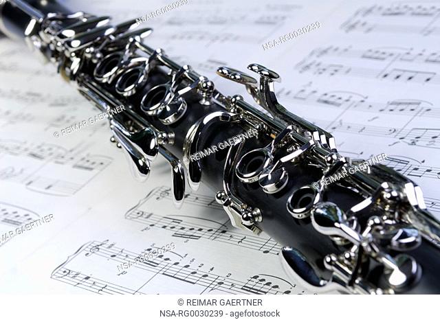 Close up of Boehm clarinet keywork on a sheet of music
