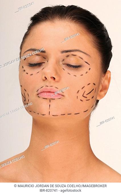 Portrait of a young woman before a cosmetic operation, plastic surgery, face covered with lines for the operation, eyes closed, dreaming