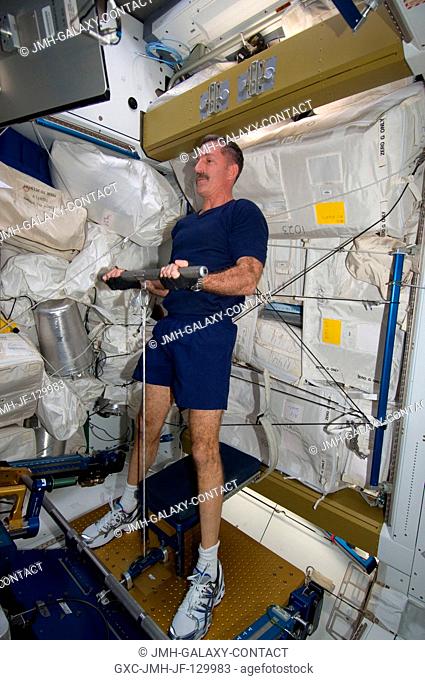 NASA astronaut Dan Burbank, Expedition 30 commander, uses the short bar for the advanced Resistive Exercise Device (aRED) equipment to perform upper body...