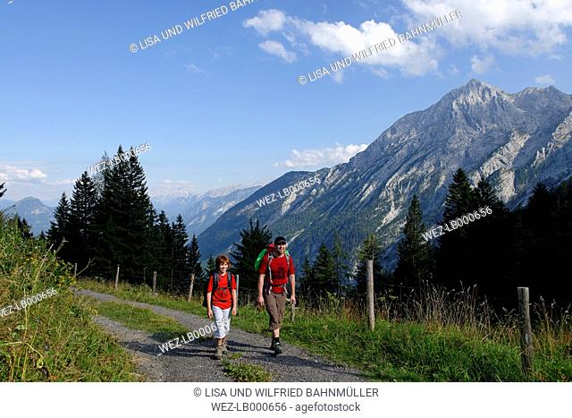 Germany, Bavaria, Berchtesgadener Land, Father and son hiking at Hoher Goell