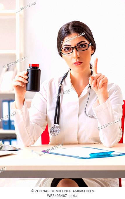 Woman doctor with bottle of medicines