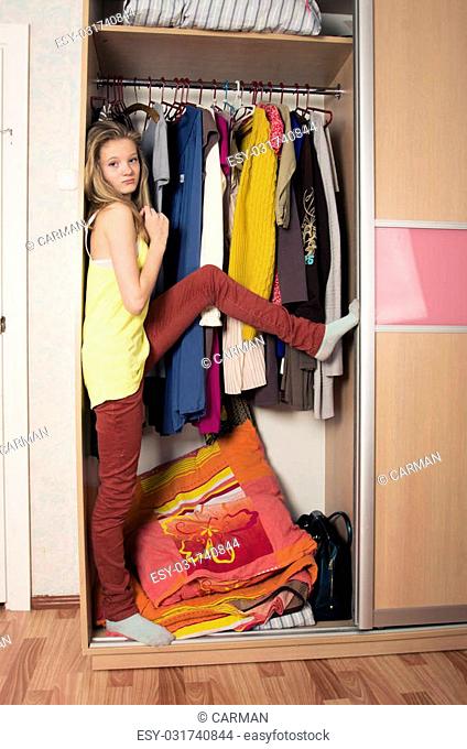 teenage girl in wardrobe at home