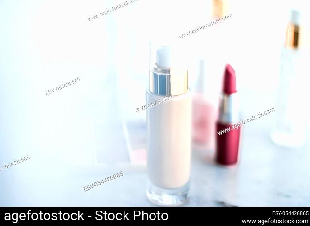 Cosmetic branding, girly and glamour concept - Cosmetics, makeup products on dressing vanity table, lipstick, foundation base