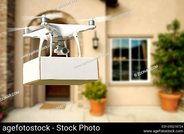 Unmanned Aircraft System (UAV) Quadcopter Drone Delivering Package At House