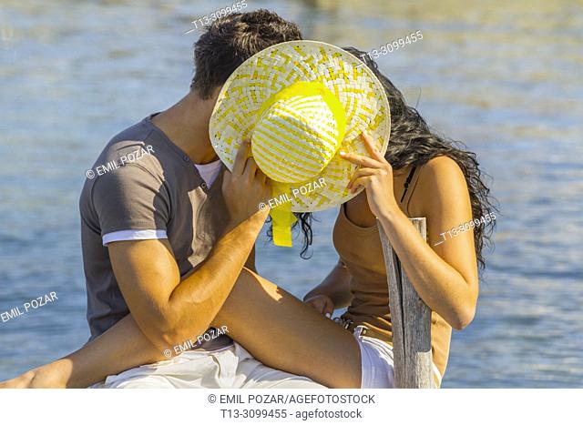 Young couple Summer vacation hiding behind Yellow hat