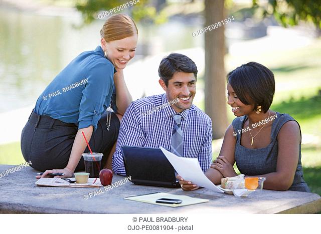Business people working in park