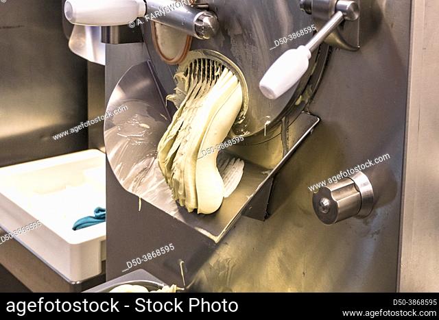 Stockholm, Sweden Ice cream comes out of a machine at a home made ice cream store in the Gubbangen suburb