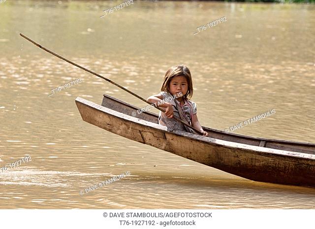 Lanten girl in her dugout canoe on the Nam Ha River, Luang Nam Tha, Laos