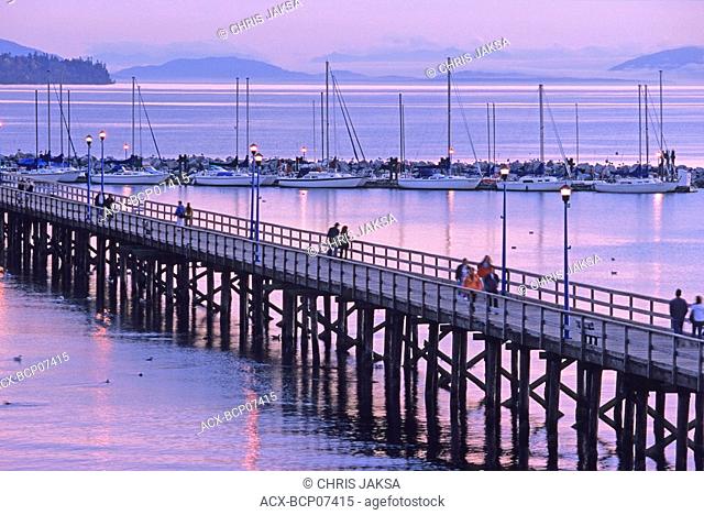 White Rock pier, 500 metres long, built in 1913 as a steamship landing dock, and Boundary Bay at twilight, White Rock, British Columbia, Canada