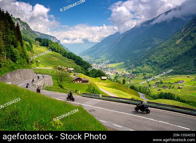 Linthtal, GL / Switzerland - 17 May 2020: A view of many motorcycles racing down the curvy Klausenpass mountain road in the Swiss Alps near Glarus