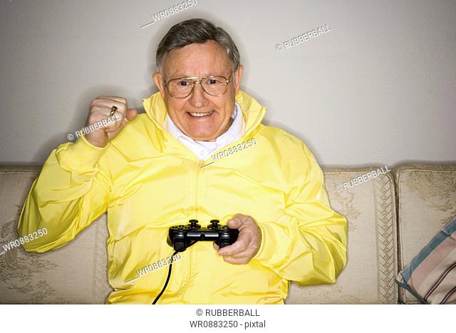 Close-up of a senior man playing a video game