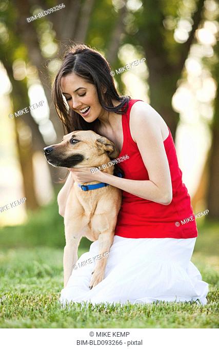 Caucasian woman petting dog