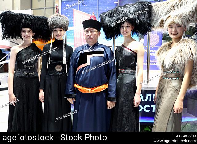 RUSSIA, MOSCOW - NOVEMBER 15, 2023: Republic of Buryatia head Alexei Tsydenov (C) poses with models in fancy costumes at the opening of Buryatia Day at Pavilion...