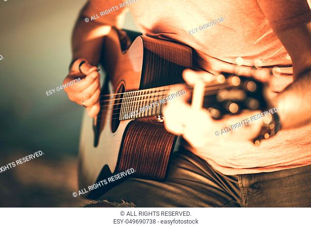Caucasian Guitarist Playing Acoustic Guitar. Closeup Music String Instrument Theme