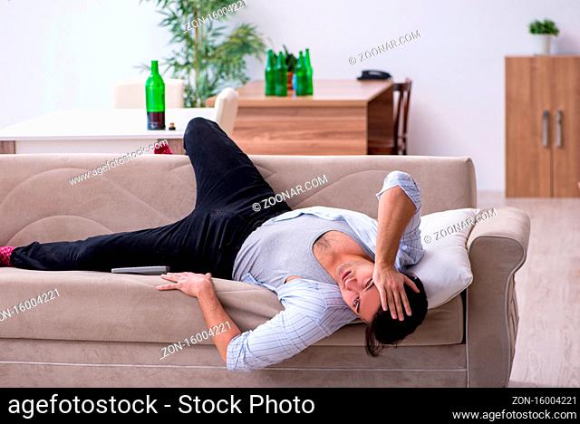 Male alcoholic drinking wine at home